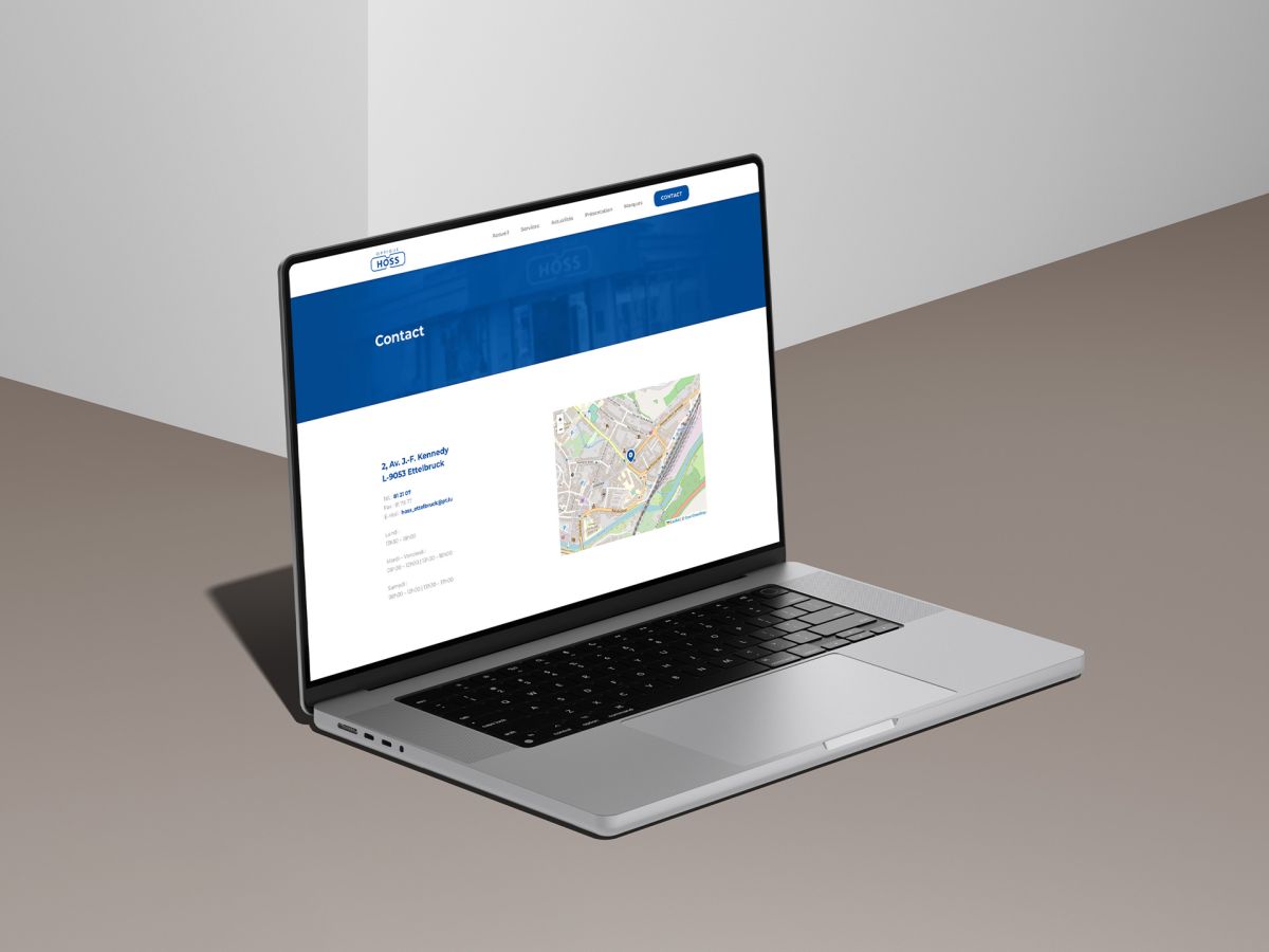 MacBook showing the contact page with corresponding navigation map on the Optique Hoss website.