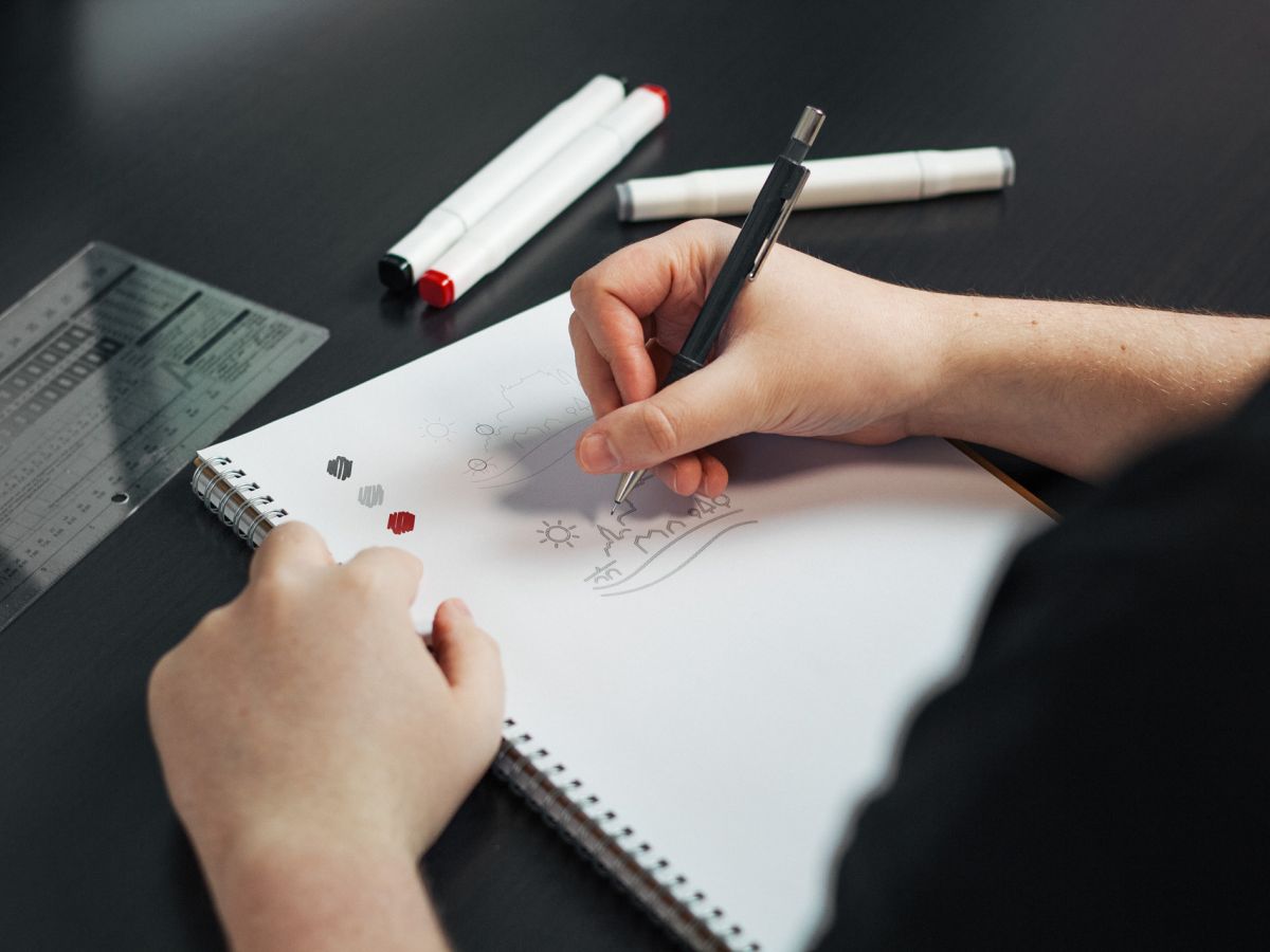Designer drawing a sketch of the Logo for Visit Vianden