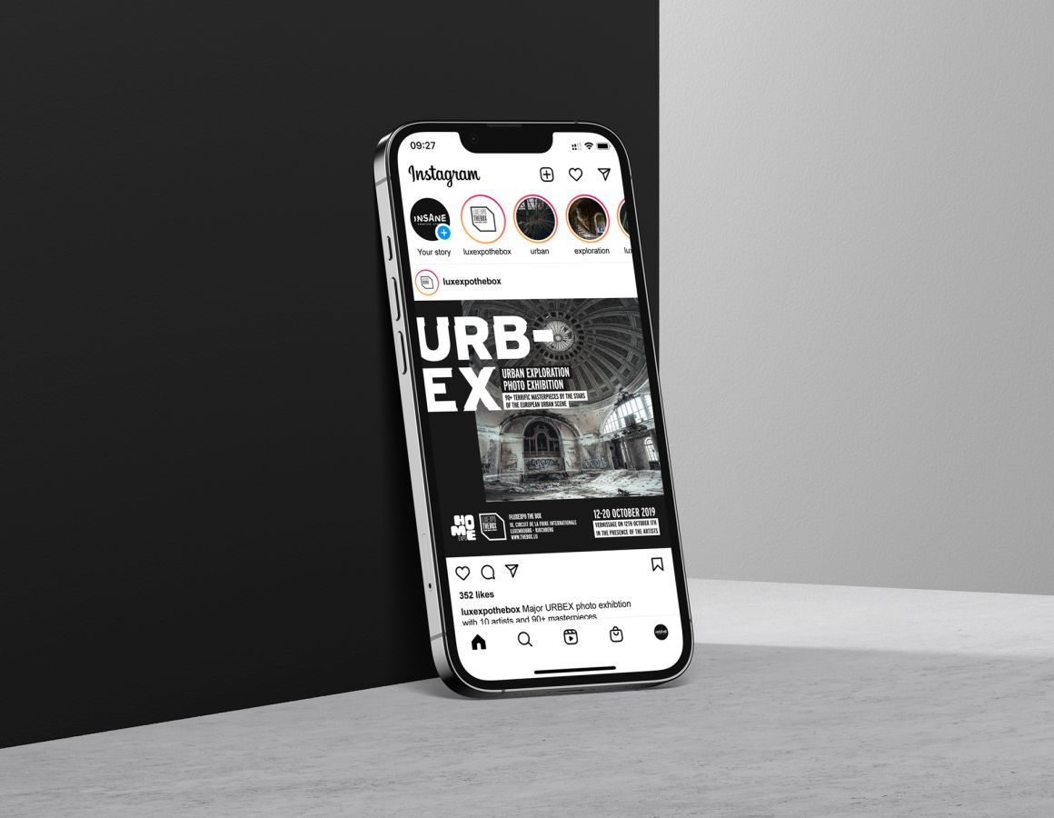 An iPhone leaning against a wall showing the social media post for the Urban Exploration Photo Exhibition organised by Luxexpo The Box.