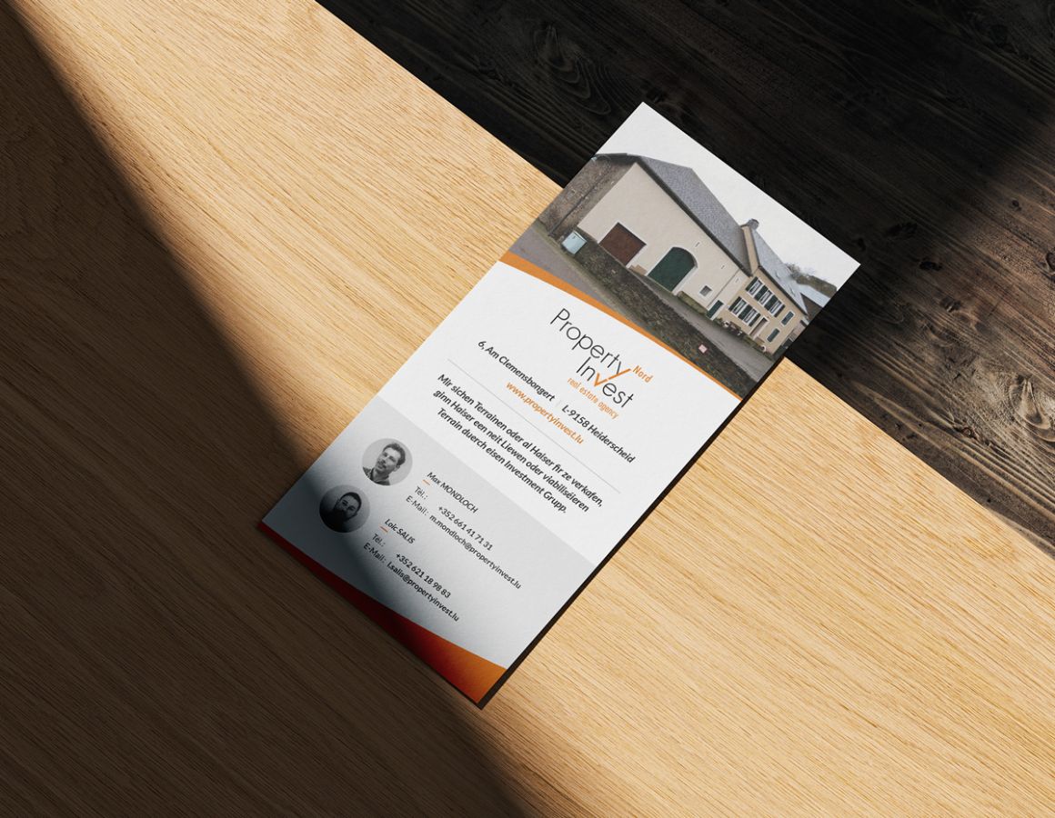Back of the DL flyer from Property Invest Nord presented on a wooden table.