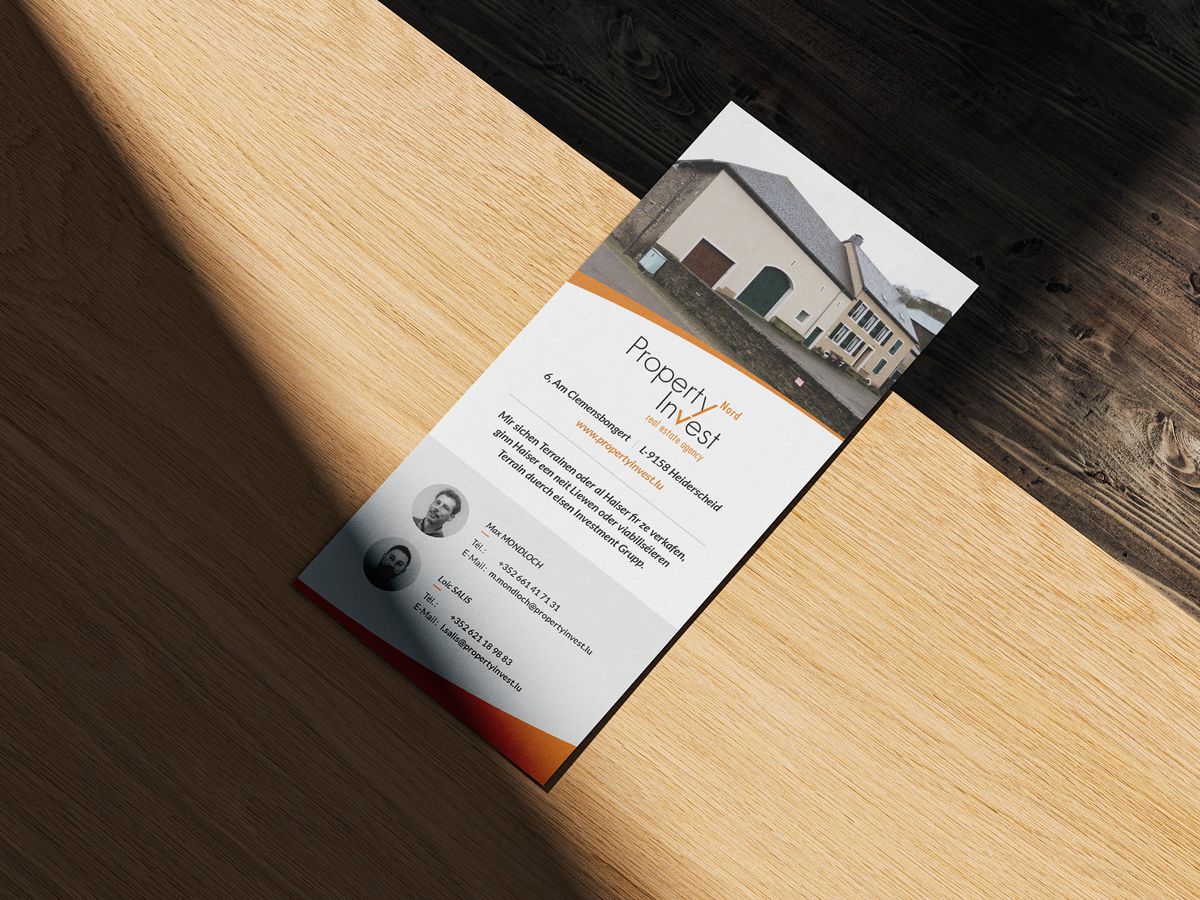 Back of the DL flyer from Property Invest Nord presented on a wooden table.